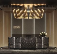 an elegant reception area with marble counter tops and wooden ceilinging, along with large planters