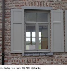 an open window on the side of a brick building