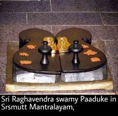 there are two pieces of metal on the ground with words written below it that read, sri raganydra swamy paduke in srrut mantalalayam