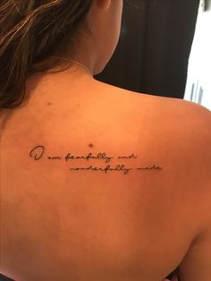 the back of a woman's shoulder with an inscription that reads, i am fearless and unattended