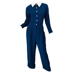 Chic vintage 80s GEOFFREY BEENE navy blue and white long sleeve silk jumpsuit ! Features a luxurious double sided silk. Buttons up the front with hidden hook-and-eye closure at top button. POCKETS at each side of the waist. White pique cotton collar. Fully lined. Can easily be dressed up or down. Expertly tailored with so much attention to detail. The majority of the work was completed by hand. In great conditon. Made in USA Marked Size US 12 Measurements: 38-40 inch bust 32 inch waist 46 inch h Vintage Long Sleeve Jumpsuit For Work, Vintage Long Sleeve Jumpsuits And Rompers For Work, Blue Long Sleeve Jumpsuit For Formal Occasions, Vintage Blue Jumpsuits And Rompers For Workwear, Fashion 1980s Women, Black Silk Jumpsuit, 1980 Clothes, 1980s Outfits, 80s Jumpsuit