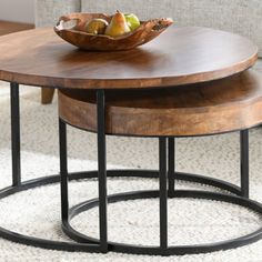 two wooden tables sitting on top of a white rug