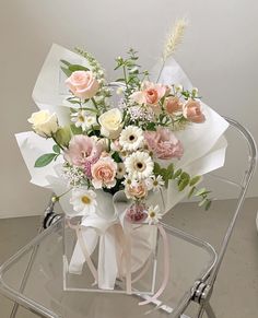 a bouquet of flowers sitting on top of a chair