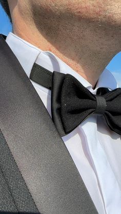 ✨ Elevate your style with our handmade black satin bow tie, exuding a boutique look. This eye-catching design features two layers of glittered satin, perfect for making a statement on your most special occasions. Whether you're a groom, attending a gala, or enjoying a costume party, this bow tie adds a touch of classic elegance with a hint of sparkle. It's a versatile choice that pairs well with any color suit or tuxedo. Fitted Bow Tie For Groom, Fitted Tuxedo Bow Tie For Groom, Bow Tie For Men, Black Bow Tie, Tie For Men, Bow Tie Wedding, Groom Attire, Mens Bow Ties, Groom Style