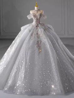 a white wedding dress with silver sequins on it