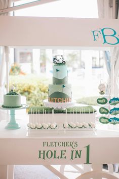 a table topped with a cake and cupcakes