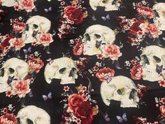 a black background with skulls and flowers on it, all in different shades of red