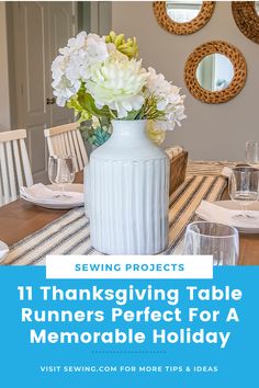 a white vase filled with flowers sitting on top of a table