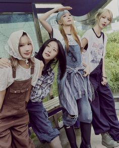 four girls are posing for the camera with their arms around each other while wearing overalls