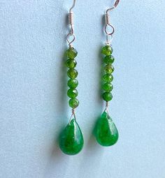 These are gorgeous drops.  May be color enhanced but the real deal.  Grass Green  Shimmering Emerald, glossy with natural inclusions.  My favorite stone and Mays' Birthstone.  Added are 2 mm Faceted Chrome Diopside that compliment the Emerald.  Sterling wire and ear wires.  Can't beat the price for these beauties.  Hanging 1 1/2 inches.  A must for Green lovers.  Thanks for looking and have a great day. Green Gemstone Round Bead Earrings, Green Gemstone Earrings With Round Beads, Grass Green, Have A Great Day, Ear Wires, Birthstone, Jewelry Earrings Dangle, Etsy Earrings, Dangle Drop Earrings