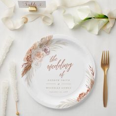 the wedding plate is decorated with flowers and leaves