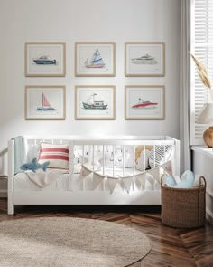 a baby's room with white furniture and pictures on the wall