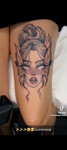 a woman's thigh with a tattoo design on the side and her face behind it