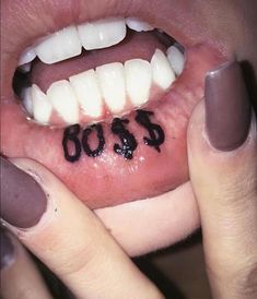 a woman holding her mouth open with the word boos written on it's tongue