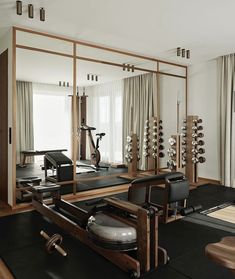 an exercise room with mirrors and equipment in it