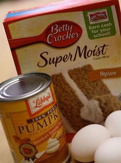 ingredients for pumpkin spice cake sitting on a counter next to an open can of pudding