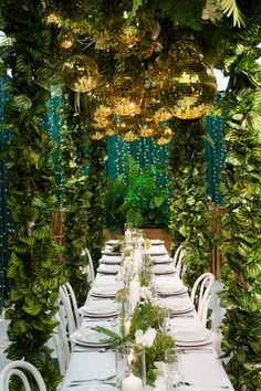 a long table set with white plates and place settings