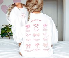 "Elevate your style with our Christian Pink Bow Balletcore Coquette Sweatshirt, a perfect fusion of fashion and faith. Adorned with a dainty pink bows, this sweatshirt exudes grace, while the small print on the front, \"God is within her, she will not fail,\" provides a daily dose of strength. The impactful large print on the back features empowering affirmations derived from various Bible verses, reminding you that you are Strong, Enough, Brave, Unique, Victorious, Chosen, Always Loved, Capable, and Beautiful. Crafted with purpose, this sweatshirt is a wearable affirmation of your spiritual journey, symbolizing the perfect blend of style, empowerment, and divine inspiration. * Q U I C K * F A C T S * ✺ 100% preshrunk cotton ✺ Wash (inside out) and dry normally (on cool for best results) * Inspirational Pink Crew Neck Top, Inspirational Long Sleeve Relaxed Fit Top, Inspirational Relaxed Fit Long Sleeve Top, Inspirational Long Sleeve White T-shirt, Coquette Clothing, Christian Crewneck, Coquette Top, Christian Sweatshirt, Pink Bows