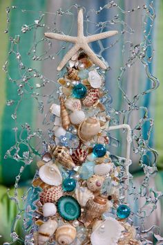 a christmas tree made out of seashells and starfish