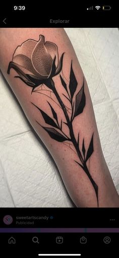 a black and white flower tattoo on the arm