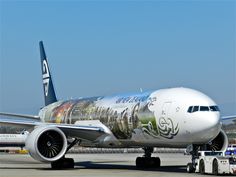 an airplane is parked on the tarmac with its wheels down