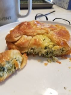 a white plate topped with pastry next to a cup