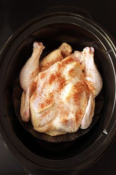 a chicken in an air fryer with spices on it