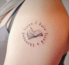 a woman with a book tattoo on her arm