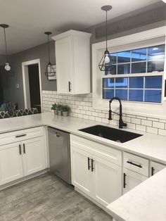 the kitchen is clean and ready to be used for cooking or baking, with all white cabinets