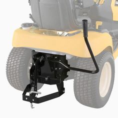 the front end of a yellow lawn mower with its wheels on it's side