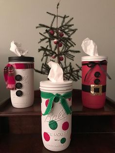 three mason jars decorated with christmas decorations