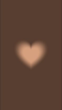 the shadow of a heart on a brown background