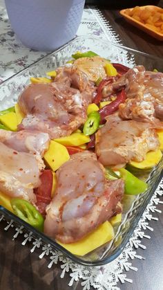 a glass casserole dish filled with meat and vegetables