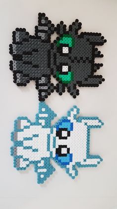 two pieces of lego art made to look like pokemons and their heads are black, white, and blue