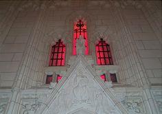 an ornate building with purple lights in the windows