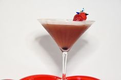 a chocolate martini with a strawberry garnish on the top in front of a white background