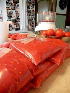 bags of tomatoes sitting on top of a counter