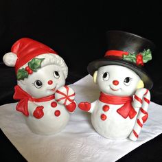 two snowmen are standing next to each other