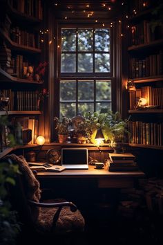 a desk with a laptop on top of it in front of a window filled with books