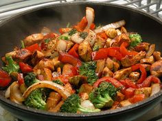 a pan filled with vegetables on top of a stove