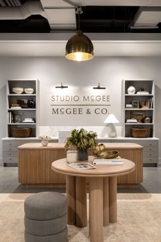 the interior of a store with furniture and accessories on display in front of a sign that reads studio mgee, megee & co