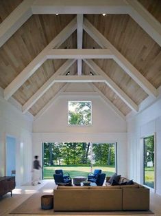 a living room filled with furniture and a circular light hanging from the ceiling above it