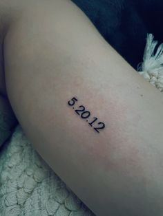 a woman's thigh with the number 2013 tattooed on her left side, in black ink