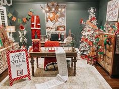 a room with christmas decorations and signs on the floor, including a santa clause statue