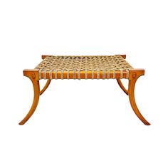 a wooden bench with woven seat cushions on the top and bottom, against a white background