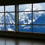 an open window with mountains in the background