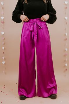 Unveil elegance with our "Best For Last" Satin Pants in Magenta. These luxurious pants exude sophistication with their smooth satin finish and vibrant magenta hue. Perfect for making a bold fashion statement at special events or elevating your everyday style. Date Night outfit inspo Waistband: High rise Fabric: 95% Polyester, 5% Spandex Sleek satin fabrication Adjustable tie belt waistband Wide leg bottom Imported Fit: True to size!- Waist: Elastic/High rise- Leg: Wide leg - Stretch only in wais Satin Pant, Style Goals, Satin Pants, Everyday Chic, Leg Stretching, Bottom Clothes, Displaying Collections, Chic Boutique, Night Outfits