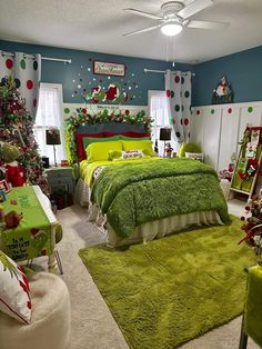 a bedroom decorated for christmas with green bedding and decorations on the walls, carpeted floor