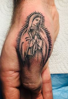 a person's hand with a tattoo on it