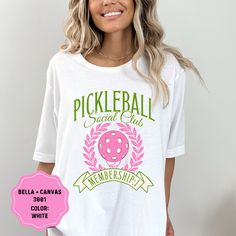 Elevate your Pickleball style with our amazing Bella + Canvas 3001 Pickleball Graphic T-Shirt! Crafted from super-soft, high-quality fabric, this tee offers the perfect blend of comfort and style for any Pickleball enthusiast. The trendy graphic design celebrates your love for Pickleball in a fun and trendy way. Whether you're on the court, at a casual hangout, or running errands, this t-shirt is sure to turn heads and make a statement. Available in a range of sizes, the Bella + Canvas 3001 tee Pink Screen Print Top For Sports Events, Short Sleeve Tops With Team Name For Pickleball, Green Graphic Print Top For Pickleball, Sporty T-shirt For Summer Pickleball, Sporty White T-shirt For Pickleball, Team Spirit T-shirt For Pickleball With Short Sleeves, Pickle Ball Tshirts, Preppy Tee, Pickleball Sports Season Graphic Print T-shirt